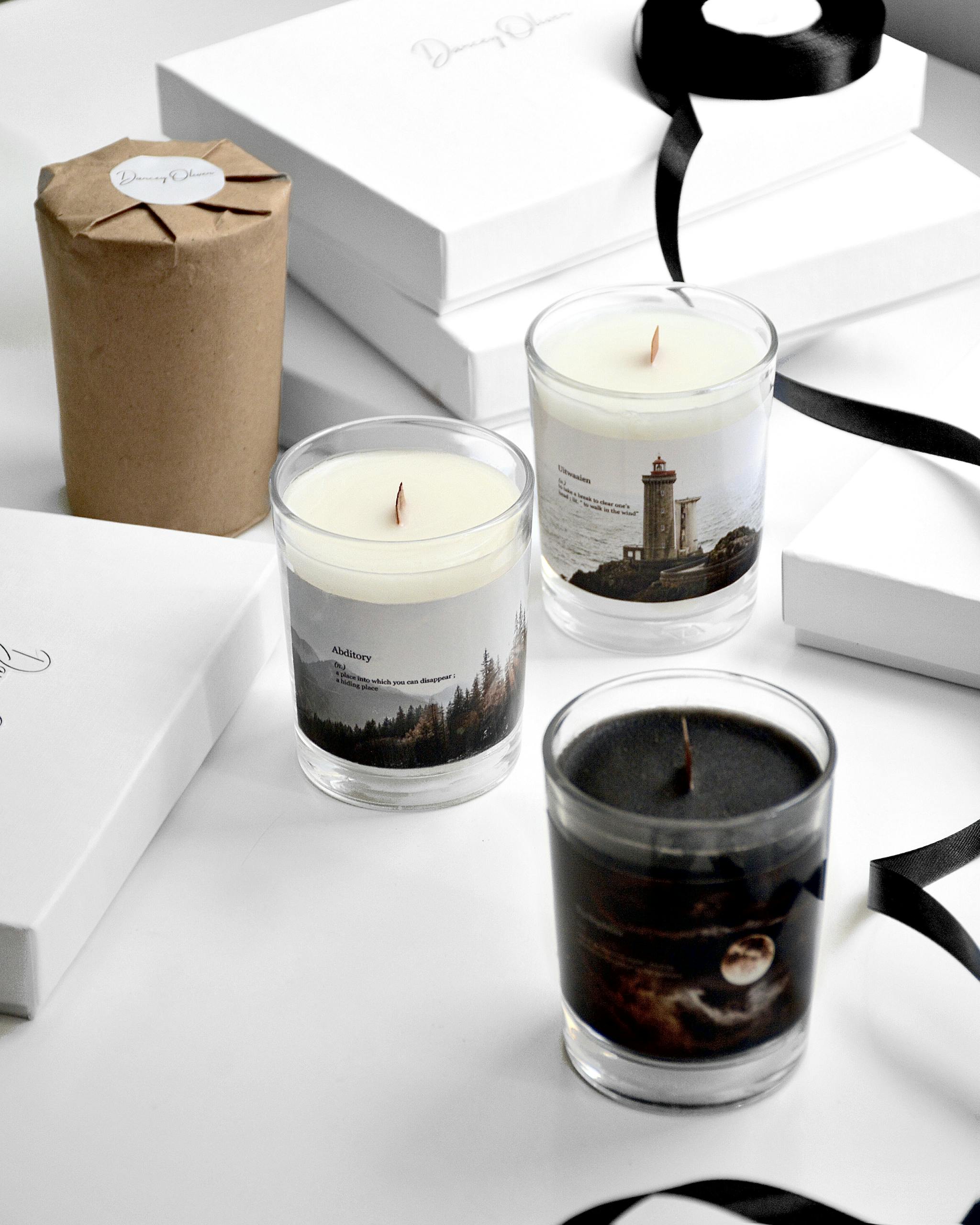 Elegant scented candles presented with modern gift boxes, perfect for decor.